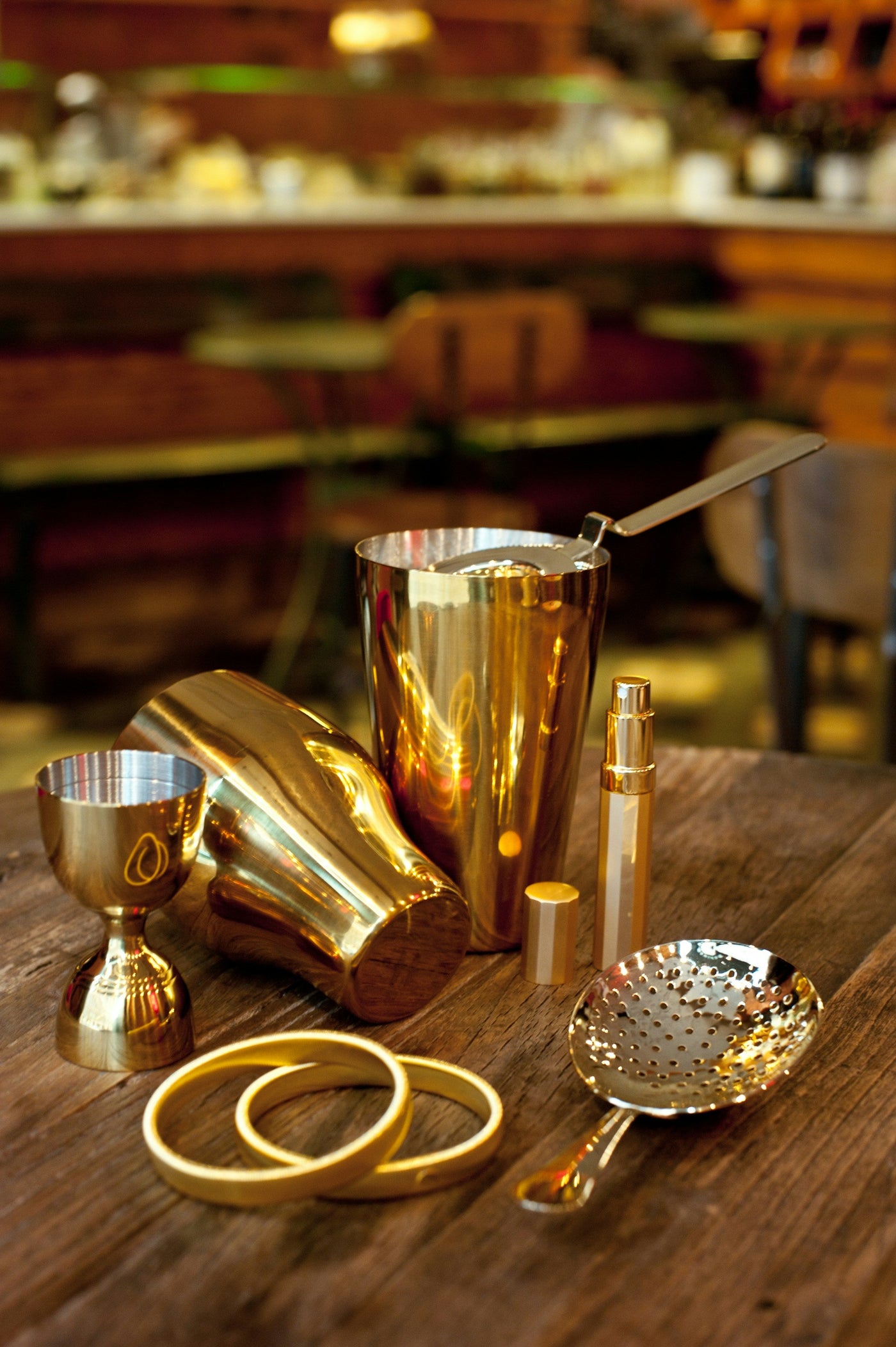 Luxurious gold PVD coated spoon and fork set on a modern Indian dining table.
