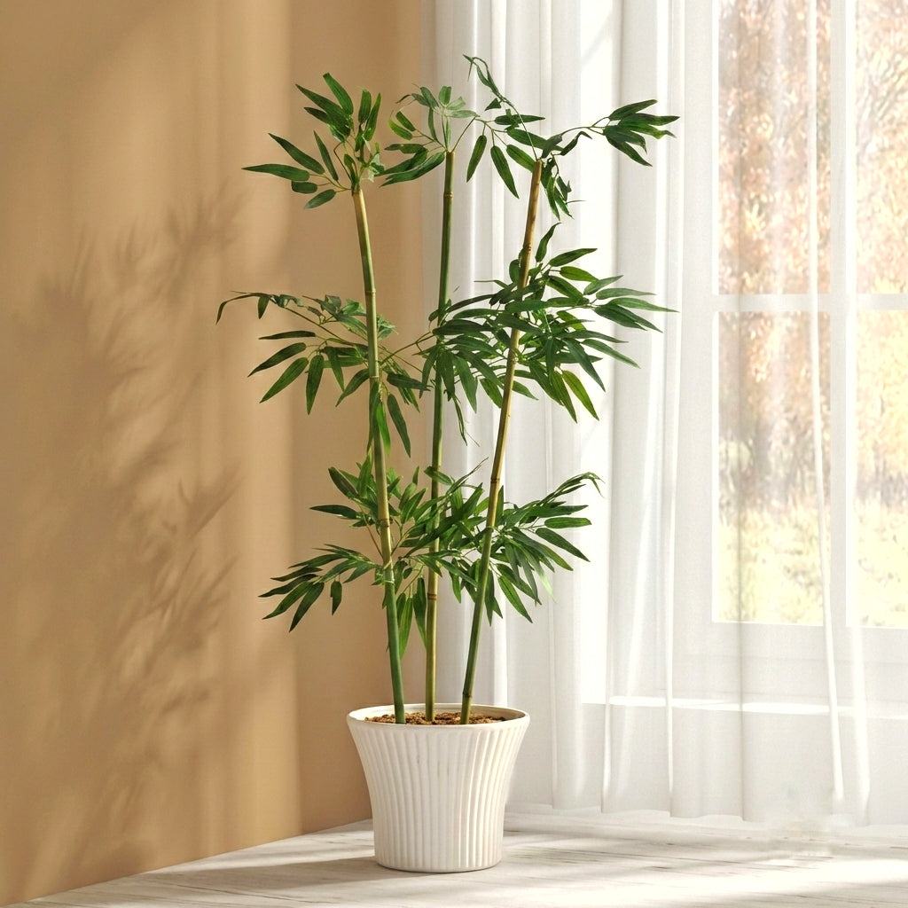 A studio shot against a solid white background showing four realistic artificial bamboo stalks featuring detailed dark green, lance-shaped leaves.