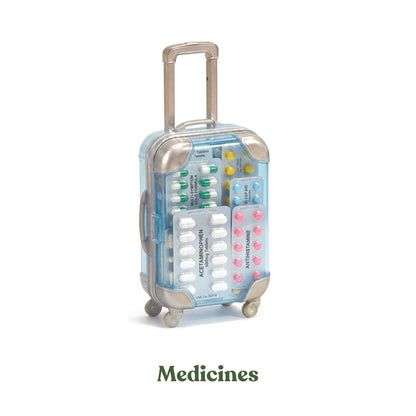 Aesthetic pink pill box travel organizer filled with medicines and vitamins in a miniature suitcase shape.