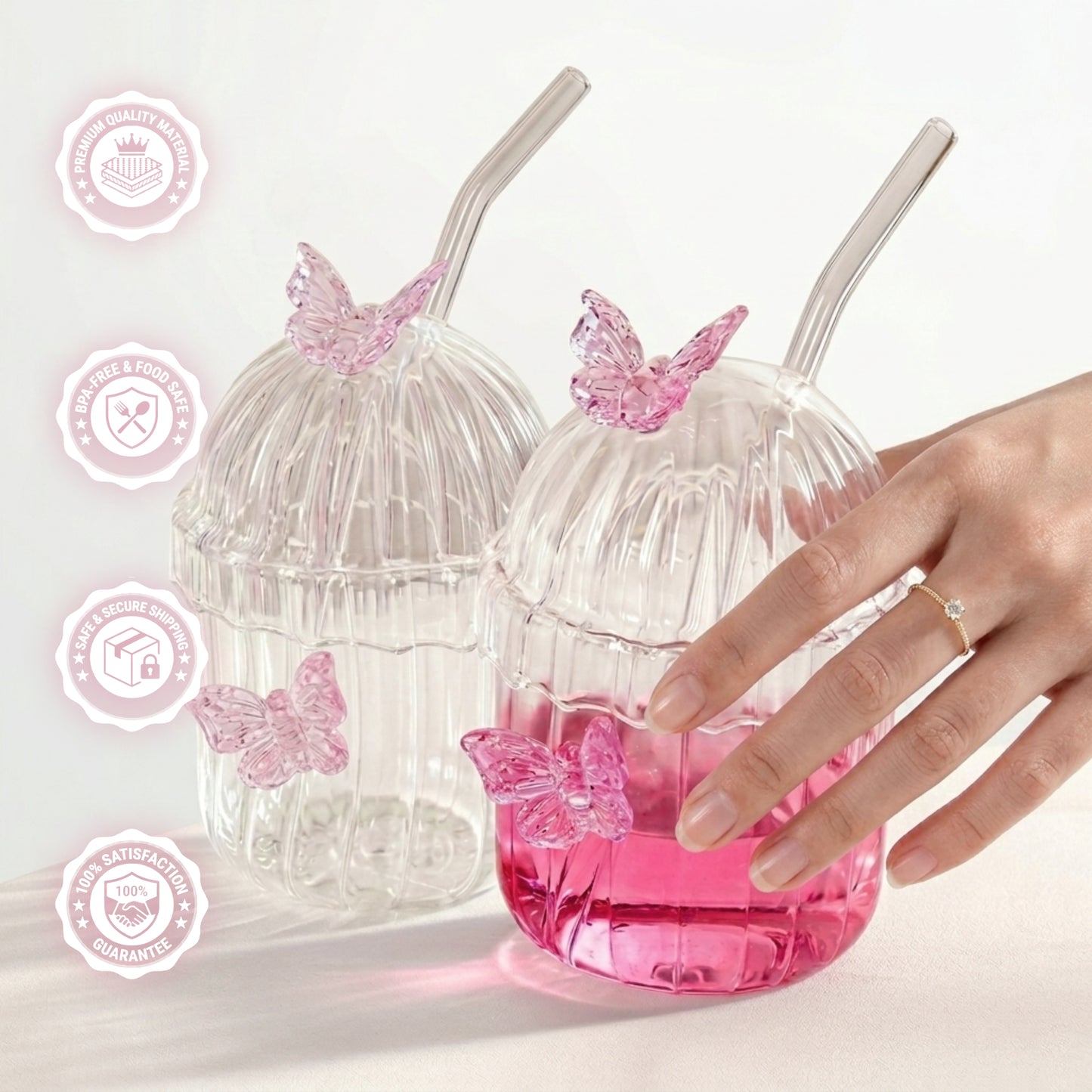 Clear ribbed glass tumbler with lid, glass straw, and 3D pink butterfly decorations on a white background with details