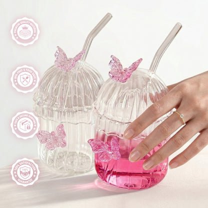 Clear ribbed glass tumbler with lid, glass straw, and 3D pink butterfly decorations on a white background with details