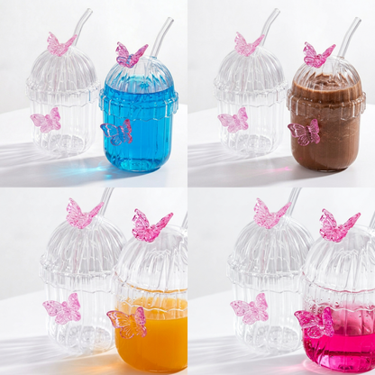 Macro shot of Clear ribbed glass tumbler with lid, glass straw, and 3D pink butterfly decorations on a white background with details