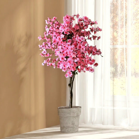 Full view of a premium artificial pink cherry blossom tree featuring vibrant faux flowers and a realistic textured trunk for indoor home decor.