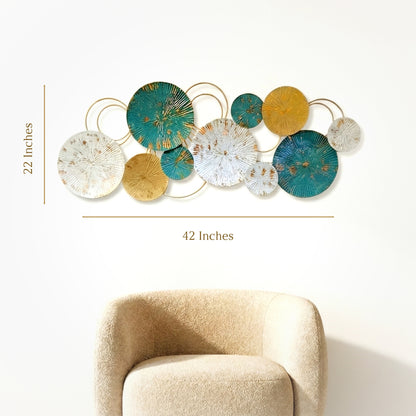Modern teal and gold metal wall art hanging above a beige armchair